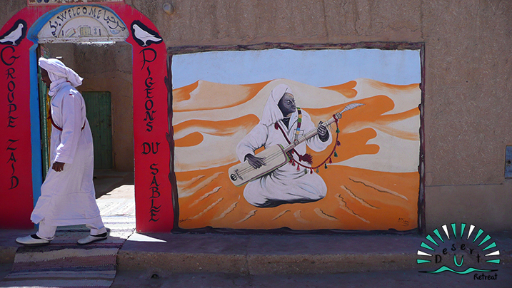 men in white froma  gnaoua spiritual music group in the sahara desert
