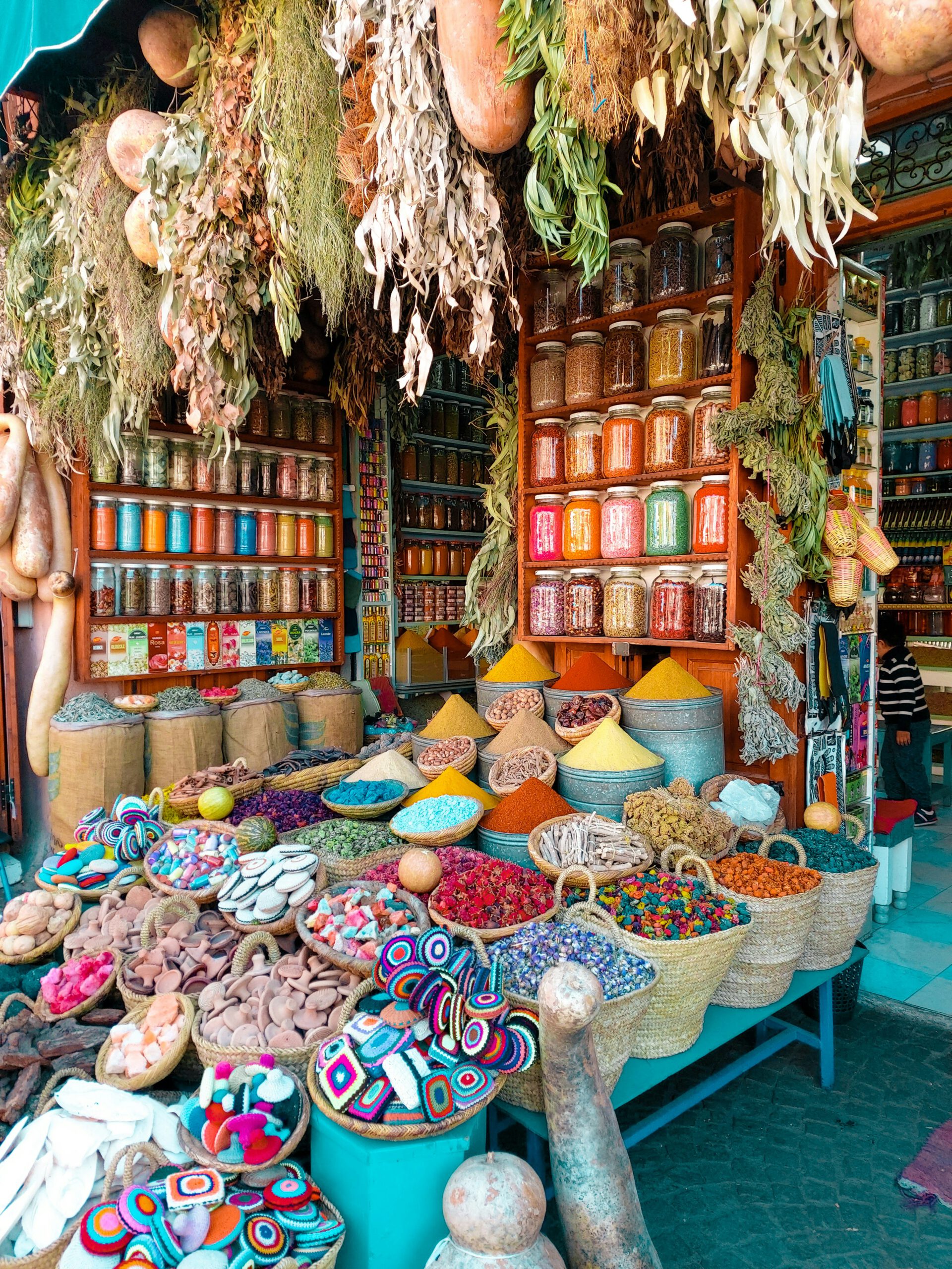 typical Morccan shop with colorful spices, herbs, baskets, glasses, beautifully arranged