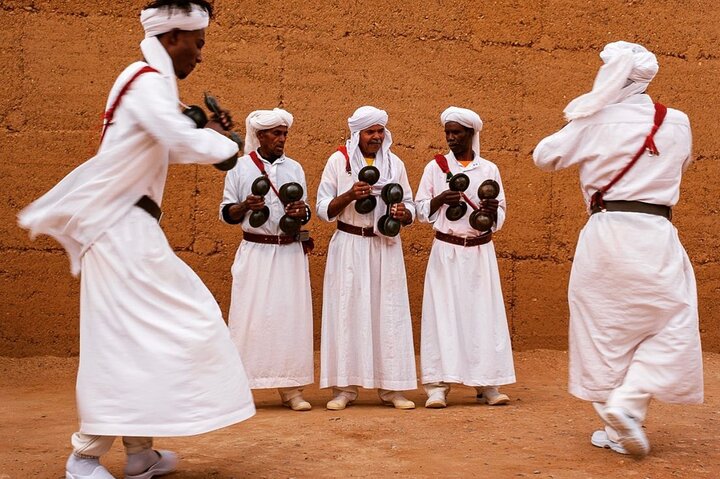 people dressed in white, dancing in morocco, sahara desert